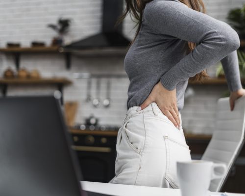side-view-woman-having-a-backache-while-working-from-home